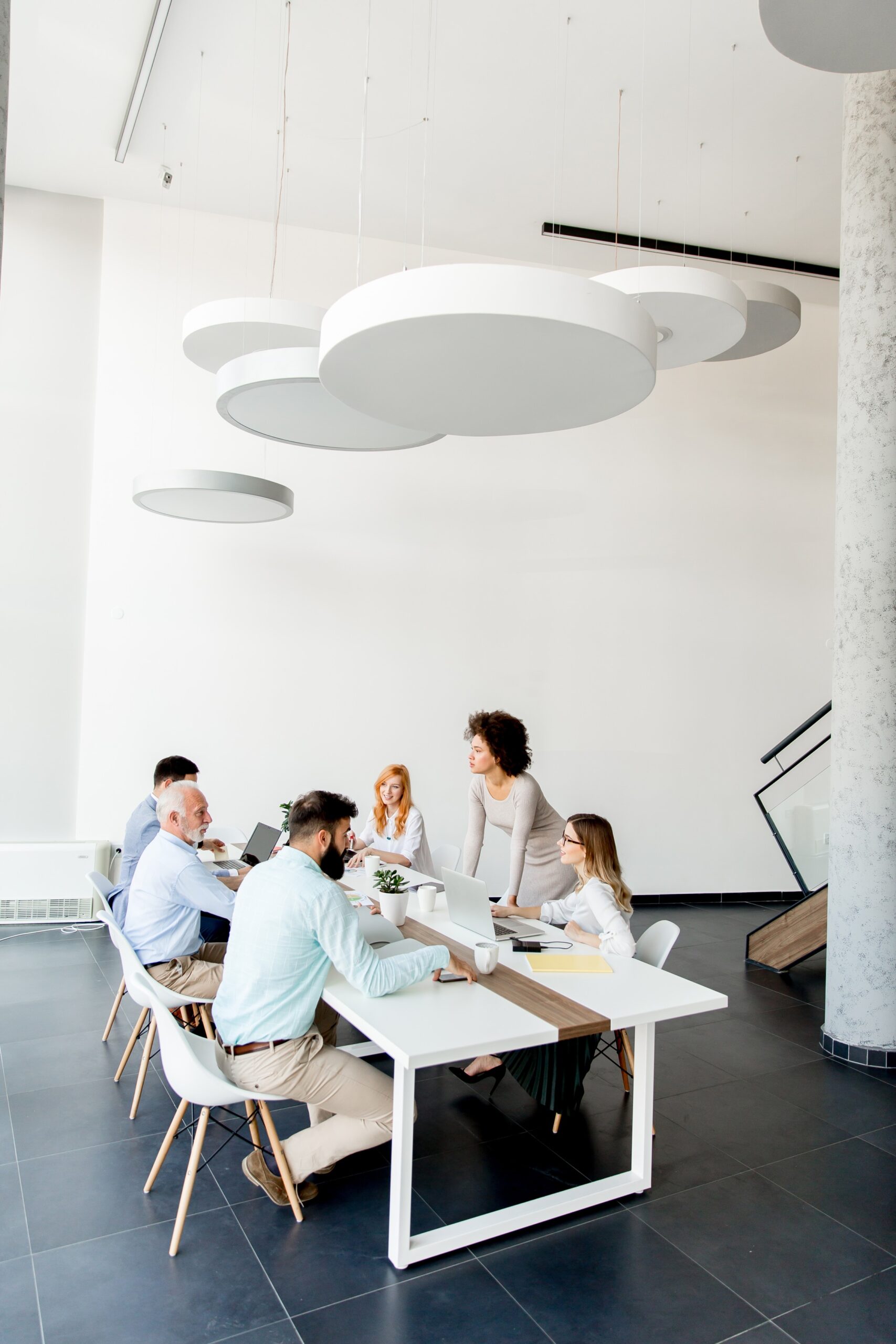 business-people-around-table-during-staff-meeting-2025-02-21-17-50-37-utc (1)